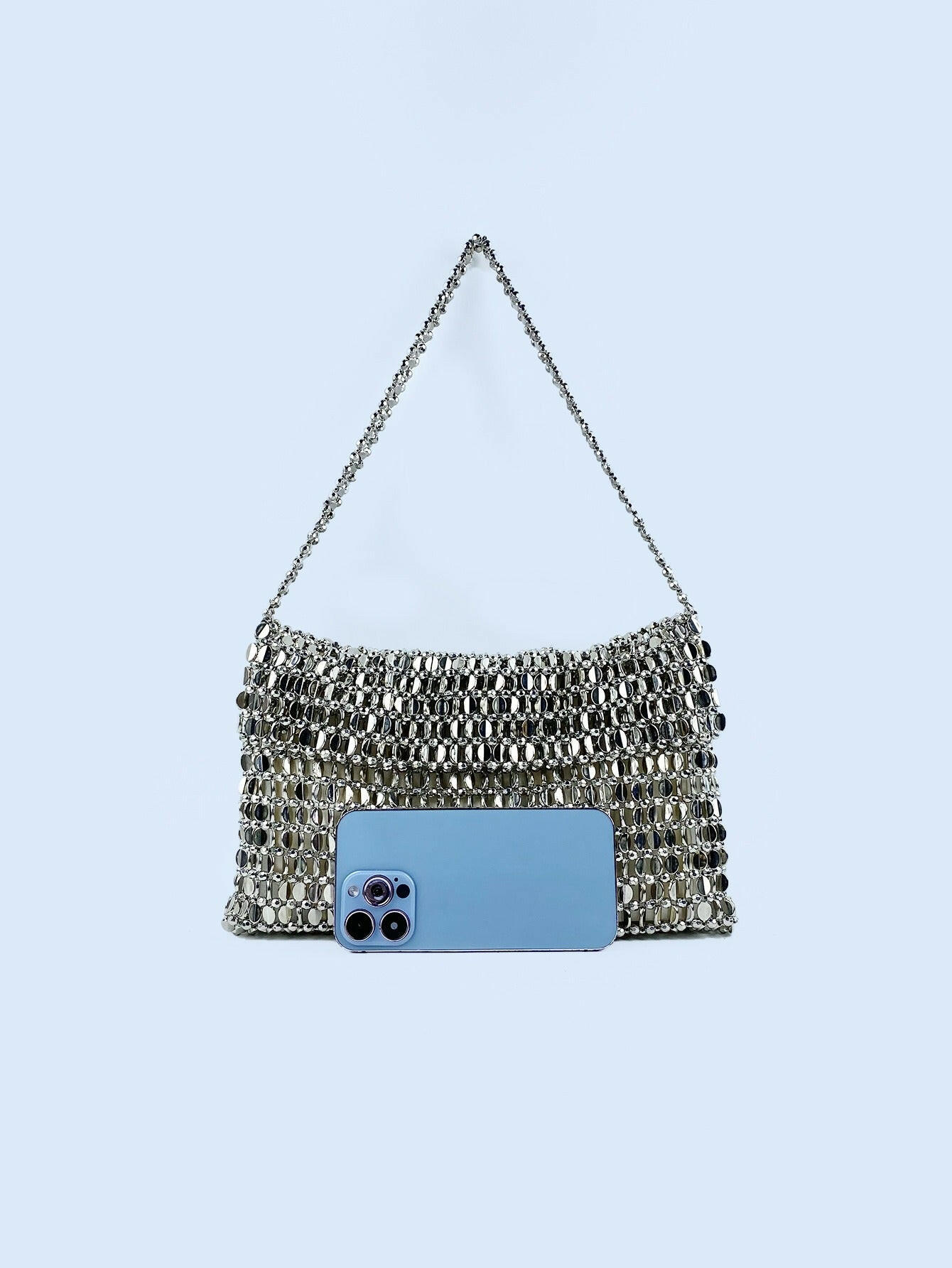 Body shaper and trackuit set paired with a stylish silver bag for a sleek, fashionable look