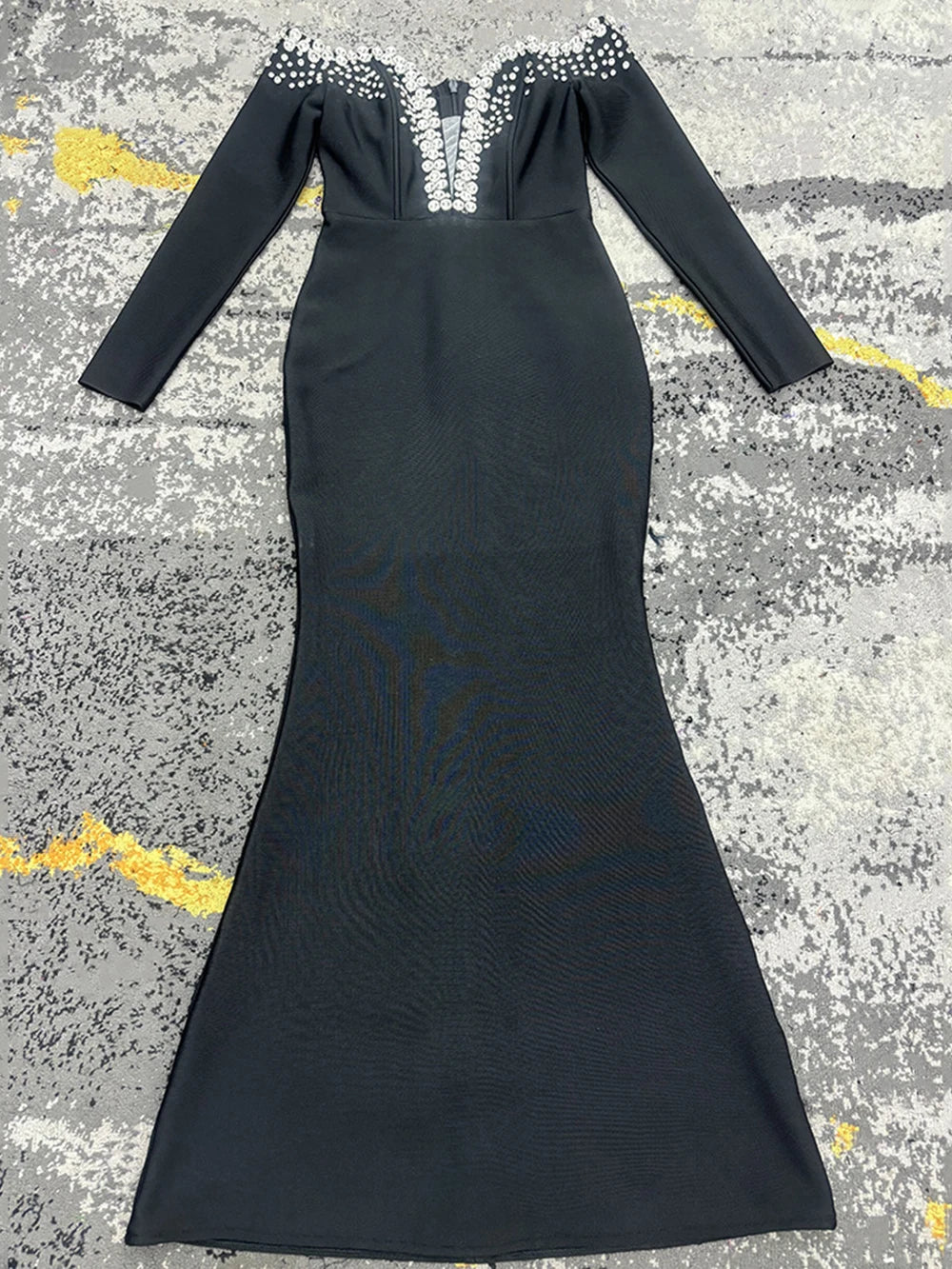 Black polyester bandage dress with beaded V-neckline and long sleeves.