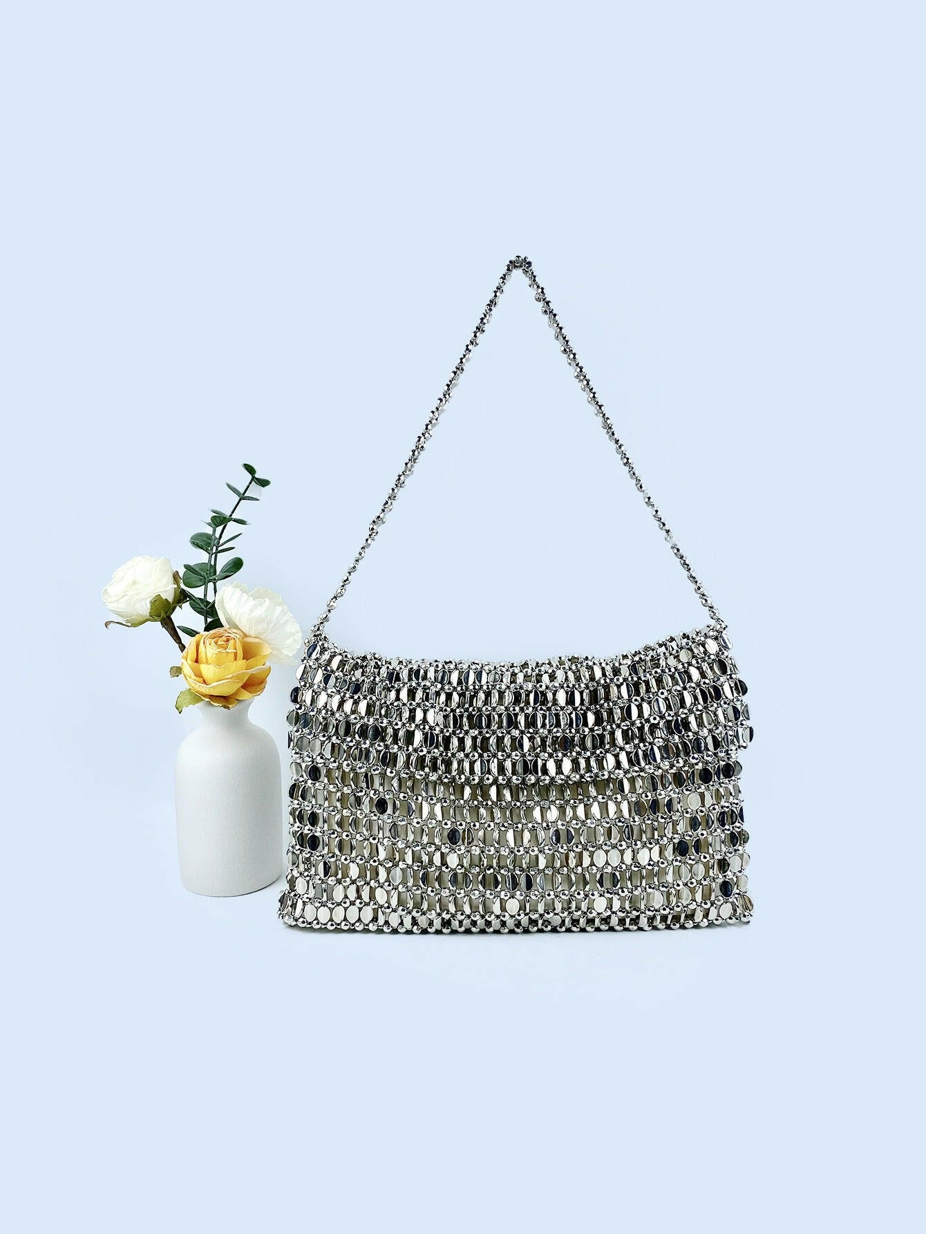 Body shaper and trackuit set paired with a stylish silver bag for a sleek, fashionable look