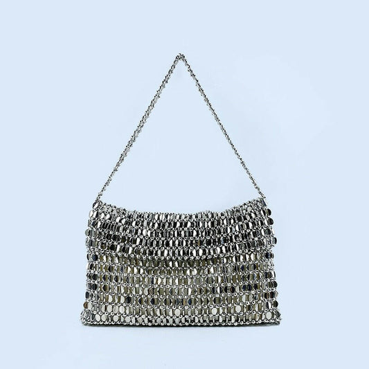 Body shaper and trackuit set paired with a stylish silver bag for a sleek, fashionable look