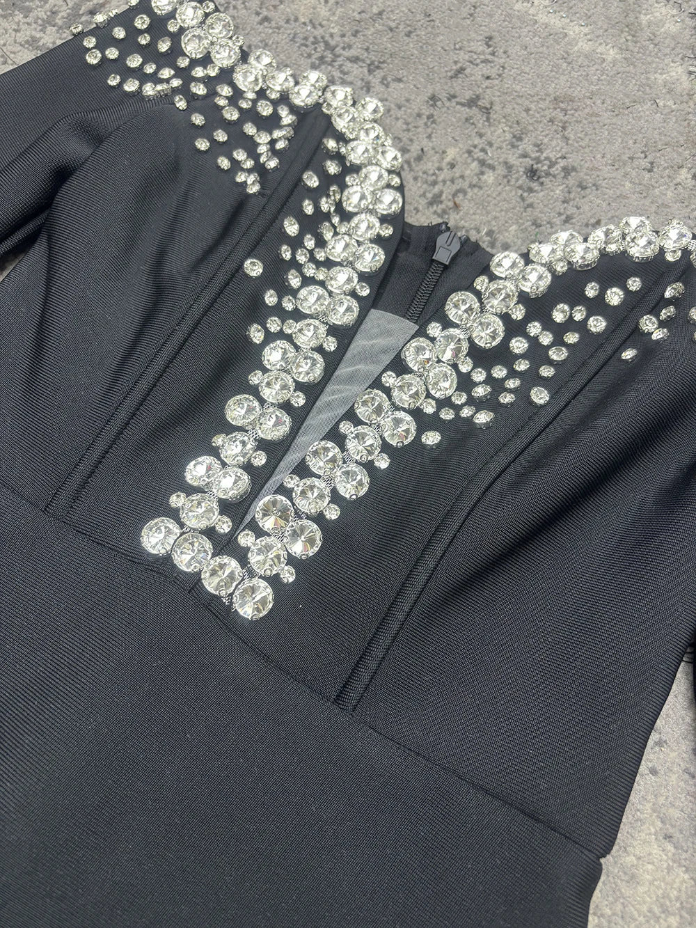 Bandage dress in black polyester with crystal-embellished neckline.