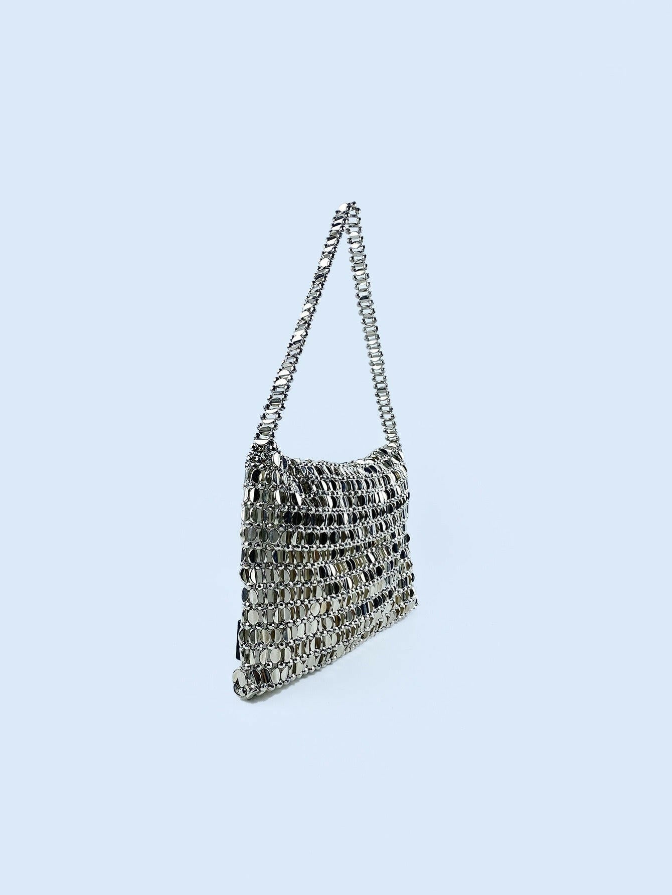 Body shaper and trackuit set paired with a stylish silver bag for a sleek, fashionable look