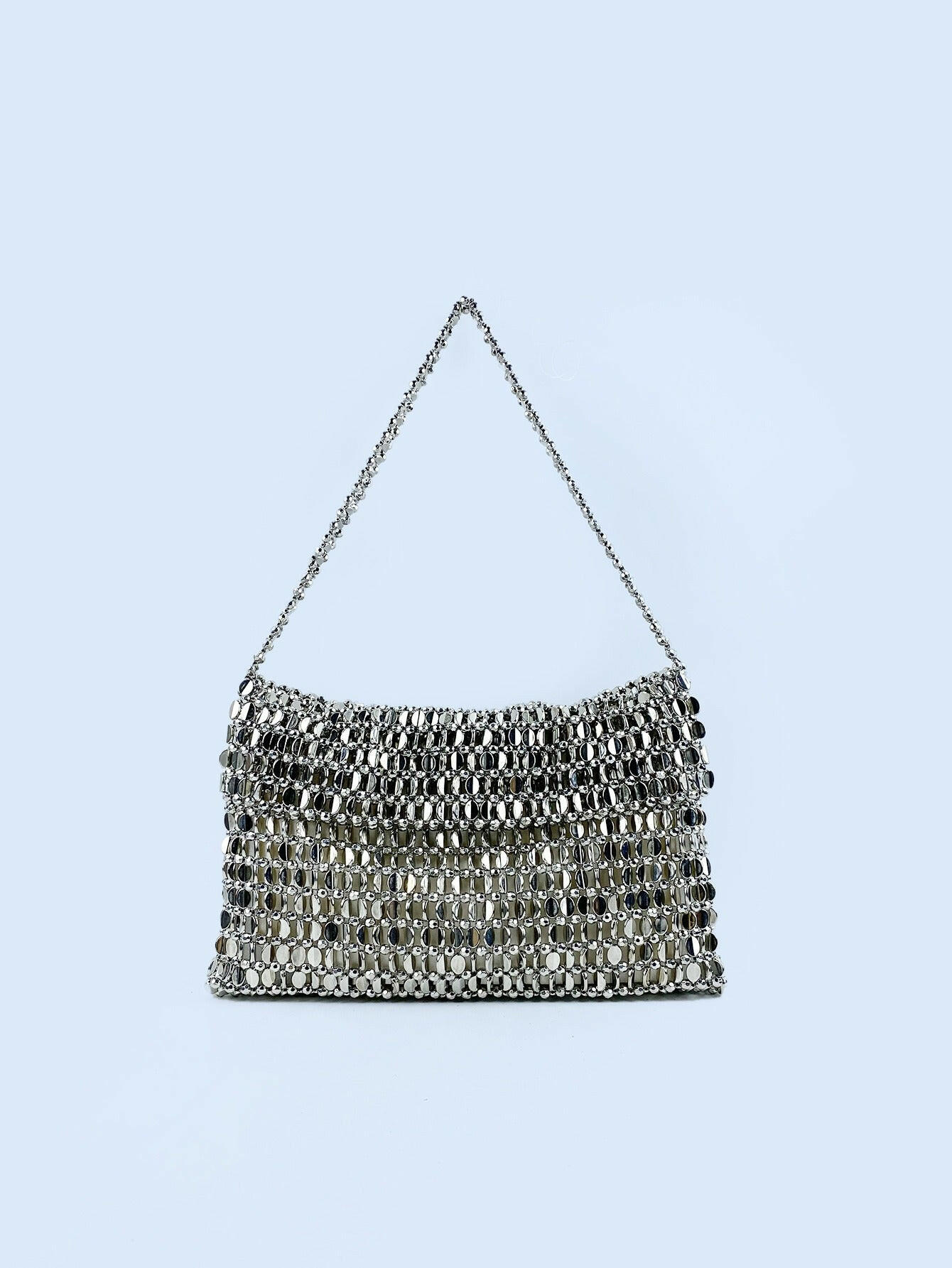 Body shaper and trackuit set paired with a stylish silver bag for a sleek, fashionable look