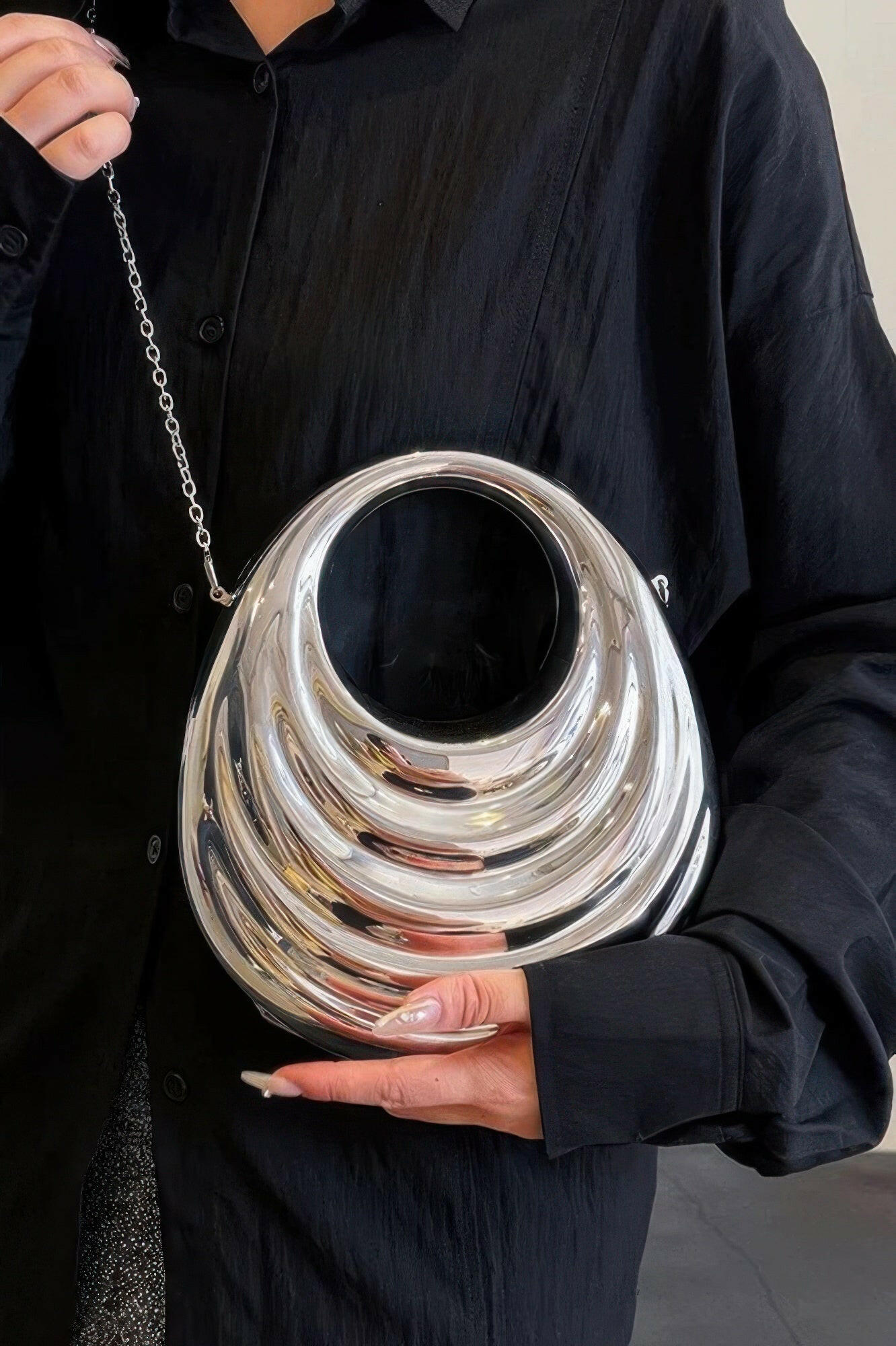 Shiny metallic acrylic bag showcasing modern design, ideal for fashion-forward individuals seeking elegant accessories.